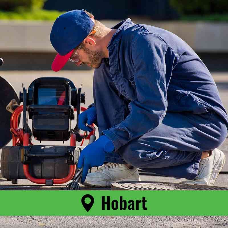Technician performing drain cleaning Hobart inside a residential basement